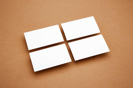 Blank sheets floating above brown background, creative. White cards. Office styled, modern mockup...