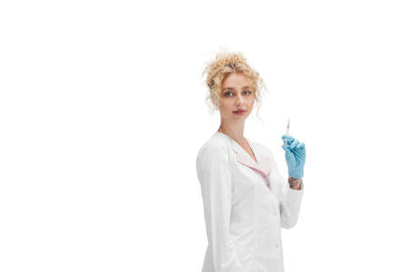 Injection. Portrait of female doctor, nurse or cosmetologist in white uniform and blue gloves over...