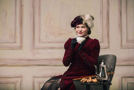 Tea break in evening. Modern trendy look of Portrait of an Unknown Woman. Retro style, comparison of...