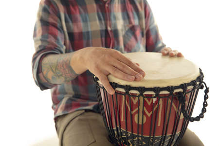 Man plays ethnic drum darbuka percussion, close up musician isolated on white studio background....