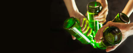 Mood. Hands of friends, colleagues during beer drinking, having fun, clinking bottles, glasses...