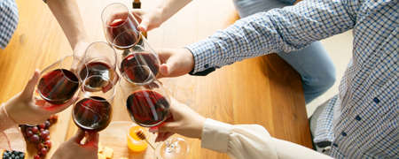 Good vibes. Hands of friends, colleagues during beer drinking, having fun, clinking bottles, glasses together. Flyer with copyspace. Oktoberfest, friendship, togetherness, happiness holidays conceptの写真素材