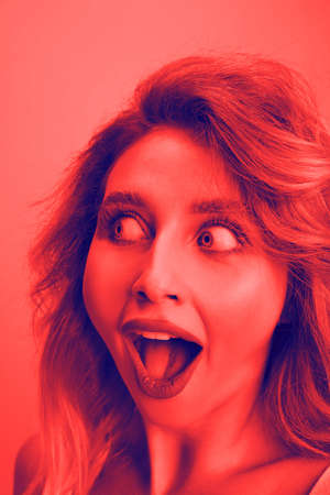 Shocked. Close up portrait of caucasian woman isolated on studio background. Modern and trendy...