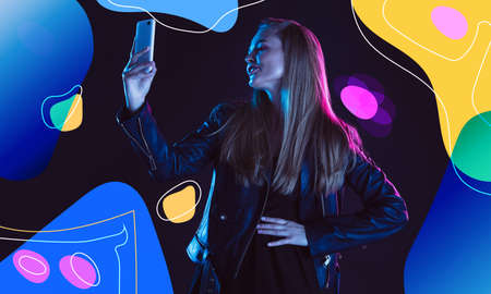 Taking selfie. Portrait of young beautiful woman in neon on modern illustrated backgound. Concept of...