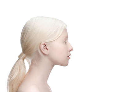 Profile. Portrait of beautiful albino woman isolated on white studio background. Beauty, fashion, skincare, cosmetics concept. Copyspace. Well-kept skin, fresh look. Inclusion and diversity.の写真素材