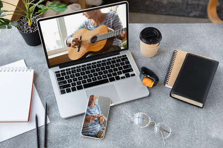 Music. Online entertainment, studying, working during quarantine, device and tech concept. COVID-19, coronavirus spreading prevention, remote work, education, training, fun. Top view of workplace.の写真素材