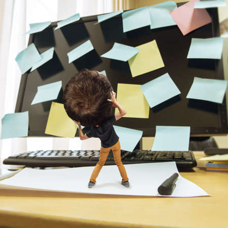 Scared. Tired man, office worker holding his huge tired head, funny. Overworked caucasian man with...