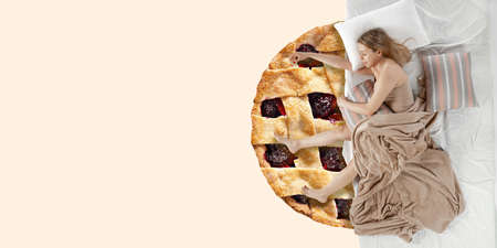 Portrait of a young caucasian girl sleeping in comfortable bed and dreaming about cake. Top view....