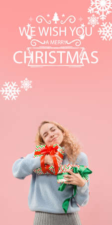 Beautiful delighted girl with gifts greeting with New Year 2021 and Christmas. Caucasian woman with...