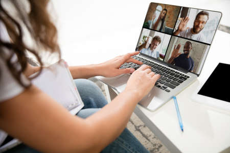 Meeting online, education. Remote working from home. Workplace in home office on sofa with laptop...