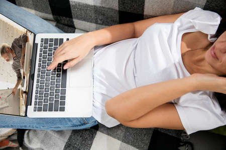 Meeting online, education. Remote working from home. Workplace in home office on sofa with laptop...
