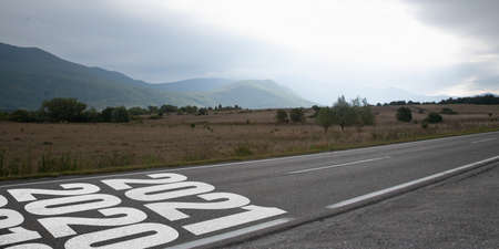 Greeting card decorated for New Year 2021 and Christmas. Landscape scenery with 2021 on the road....