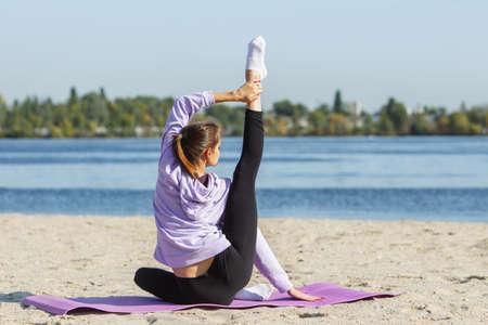 Energy. Young female athlete, woman training, practicing outdoors in autumn sunshine. Beautiful...