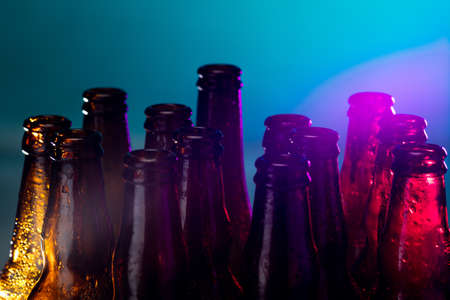 Blue. Neon colored beer bottles, close up isolated on bright studio background. Concept of beer,...