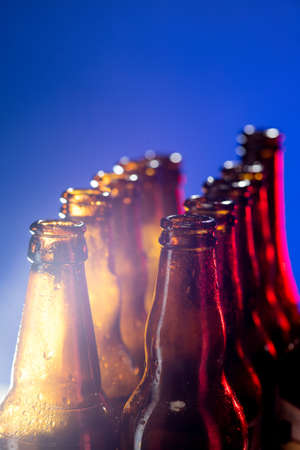 Navy. Neon colored beer bottles, close up isolated on bright studio background. Concept of beer,...
