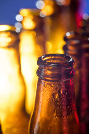 Navy. Neon colored beer bottles, close up isolated on bright studio background. Concept of beer, beverage, entertainment and alcohol. Copyspace for your bar, restaurant, brewery or shop advertising.の写真素材