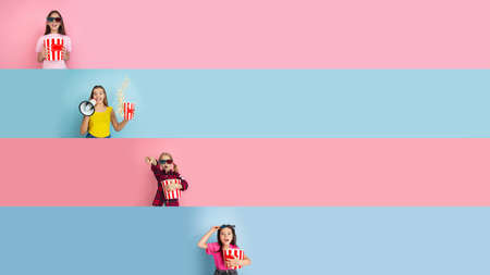 Cinema time. Young and happy caucasian kids gesturing isolated on multicolored studio background....