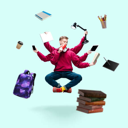 Handsome student, multi-armed man levitating isolated on blue studio background with equipment....