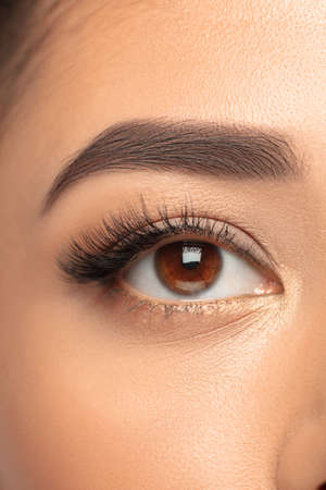 Eye. Close up portrait of beautiful young woman on studio background. Concept of cosmetics, makeup, natural and eco treatment, skin care. Shiny and healthy look, fashion, healthcare. Details.の写真素材