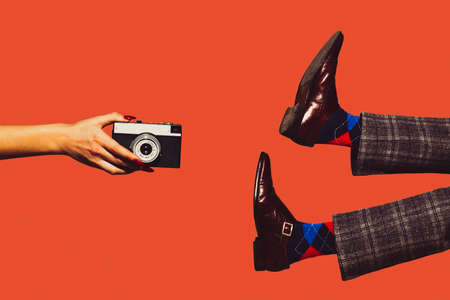 Camera and shoes. Modern art collage in pop-art style. Hands and legs isolated on trendy colored background with copyspace, contrast. Modern design with copyspace for advertising. Trendy colors.の写真素材
