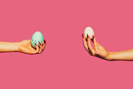 Eggs. Modern art collage in pop-art style. Hands isolated on trendy colored background with copyspace, contrast. Modern design with copyspace for advertising. Trendy colors.の写真素材