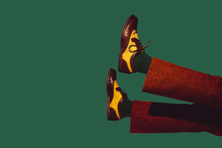 Stylish shoes, outfit. Modern art collage in pop-art style. Legs isolated on trendy colored background with copyspace, contrast. Modern design with copyspace for advertising. Trendy colors.の写真素材