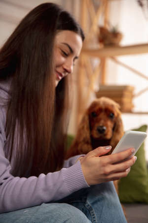 Woman reading message, greetings for New Year and Christmas 2021 from friends or family with her...