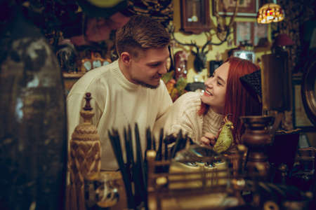 Parrot. Smiling family, caucasian couple looking for home decoration and holidays gifts in household store. Stylish and retro things for greetings or design. Interior renovation, celebrating time.の写真素材