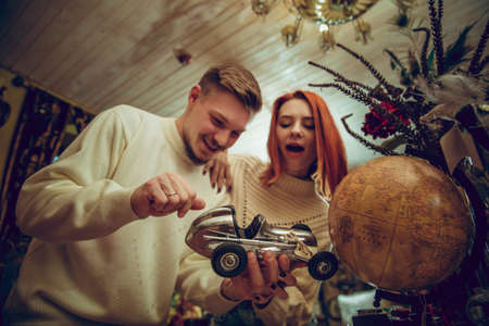 Globe. Smiling family, caucasian couple looking for home decoration and holidays gifts in household store. Stylish and retro things for greetings or design. Interior renovation, celebrating time.の写真素材