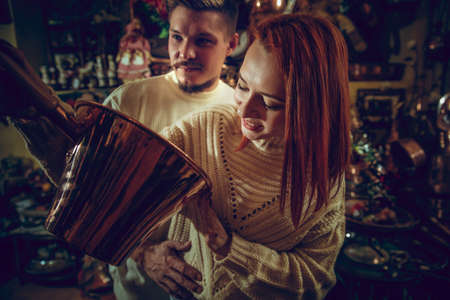 Golden. Smiling family, caucasian couple looking for home decoration and holidays gifts in household...