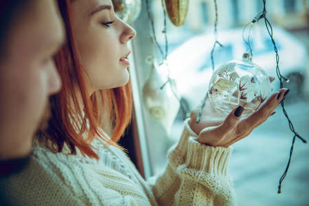 Snowly. Smiling family, caucasian couple looking for home decoration and holidays gifts in household store. Stylish and retro things for greetings or design. Interior renovation, celebrating time.の写真素材