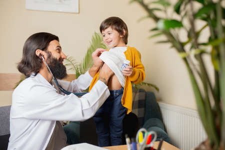 Paediatrician doctor examining a child in comfortabe medical office. Healthcare, childhood,...