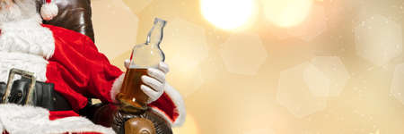 Greeting flyer for ad. Concept of Christmas, 2021 New Years, winter mood, holidays. Copyspace, postcard. Santa in traditional costume drinking beer isolated on golden bokeh background. Horizontalの写真素材