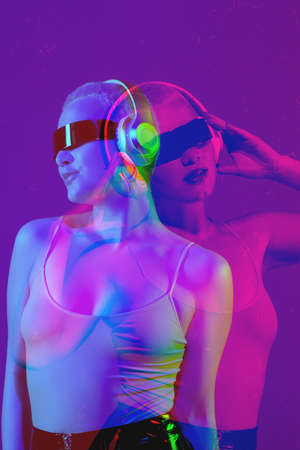Close up portrait of caucasian woman using devices, gadgets on studio background. Modern and trendy...