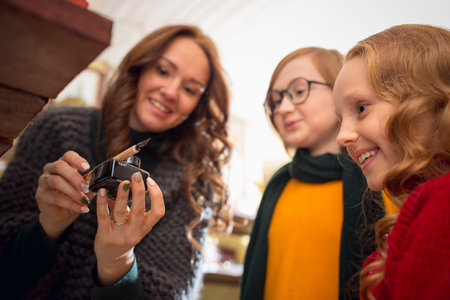 Inkwell. Cheerful family, mother and kids looking for home decoration and holidays gifts in household store. Stylish retro things for greetings or design. Interior renovation, celebrating time.の写真素材