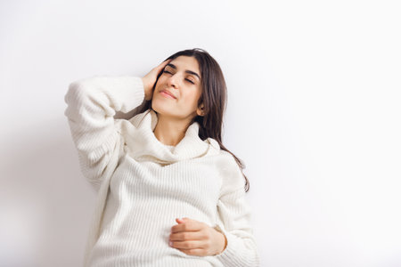 Inspiration. Portrait of beautiful brunette woman in comfortable soft longsleeve isolated on white...