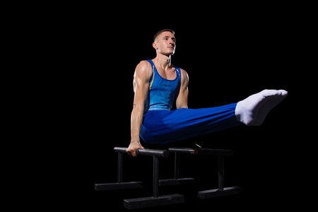 Experience. Muscular male gymnast training in gym, flexible and active. Caucasian fit guy, athlete...