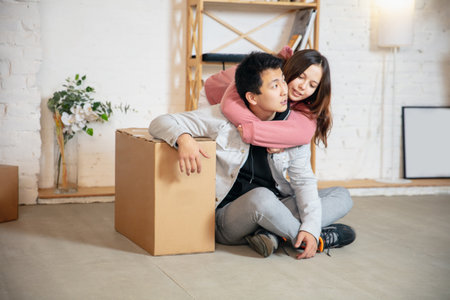 Comfort. New property owners, young couple moving to new home, apartment, look happy. Dream, love,...