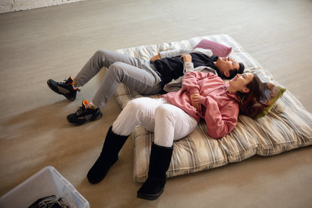 Dreamful. New property owners, young couple moving to new home, apartment, look happy. Dream, love, relationship, real estate and interior concept. New life together. Caucasian woman and asian man.の写真素材