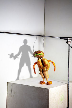 Athlete made of croissants, burgers, kiwi, icecream. Flying food composition making beautiful...