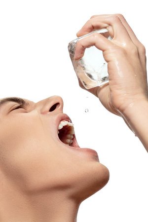 Extremely. Portrait of young man isolated on white studio background. Caucasian attractive male model. Concept of fashion and beauty, self-care, body and skin care. Handsome boy with well-kept skin.の写真素材