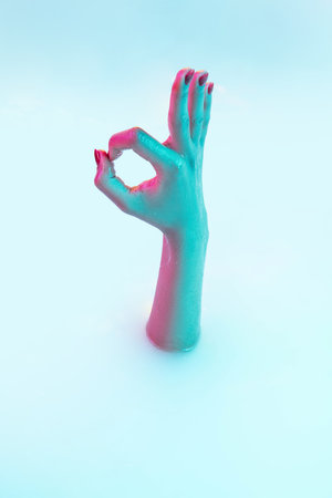 Nice, ok symbol. Close up female hand gesturing from the milk bath with soft white glowing in neon...