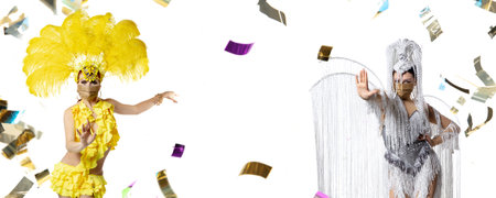 Beautiful young women in carnival, stylish masquerade costume with feathers dancing on white background with shining neoned confetti. Concept of celebration, festive, party. Flyer with copyspaceの写真素材