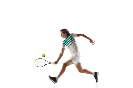 Attented. Young caucasian professional sportsman playing tennis isolated on white background. Training, practicing in motion, action. Power and energy. Movement, ad, sport, healthy lifestyle concept.の写真素材