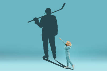 Childhood and dream about big and famous future. Conceptual image with boy and shadow of sportive...