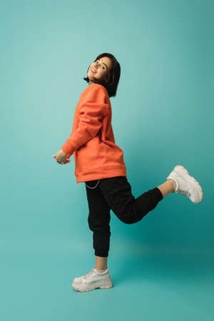 Having fun. Caucasian womans portrait isolated on blue background with copyspace. Beautiful female...