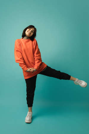 Having fun. Caucasian womans portrait isolated on blue background with copyspace. Beautiful female...