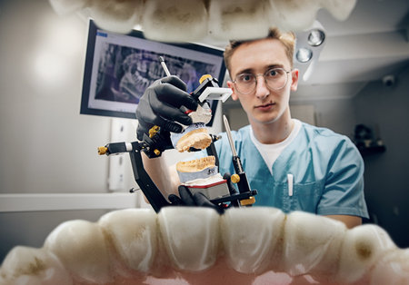 Scaring a patient. Doctor looking into mouth, checking, examining teeth. Using professional tools and equipments. Healthcare and medicine, stomatology, feelings of patient. Look from inside the teeth.の写真素材