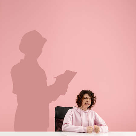 Young caucasian woman dreaming about future in big science during her work in office. Shadow,...