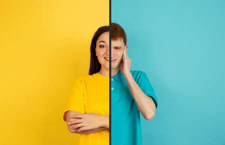 Scared man and confident woman. Fun and creative combination of portraits of young people with different emotions, various facial expression on splited multicolored background. Copyspace for ad.の写真素材